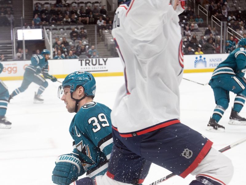 Mar 14, 2023; San Jose, California, USA; Columbus Blue Jackets defenseman Nick Blankenburg (77) tries to avoid San Jose Sharks center Logan Couture (39) during the first period at SAP Center at San Jose. Mandatory Credit: D. Ross Cameron-USA TODAY Sports