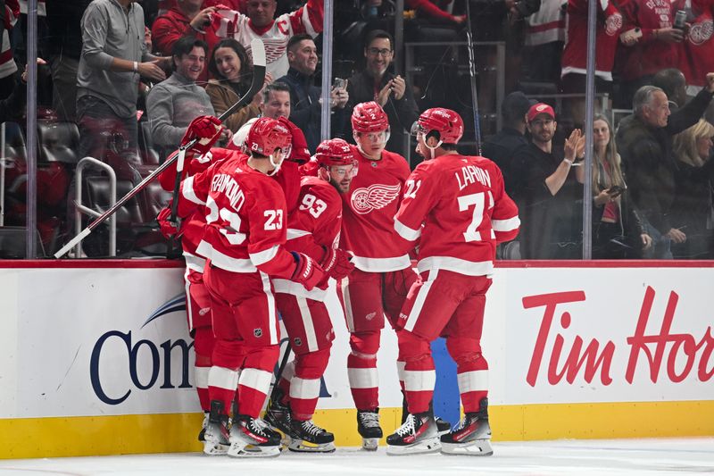 Oct 10, 2024; Detroit, Michigan, USA; Detroit Red Wings right wing Alex DeBrincat (93) celebrates his goal with left wing Lucas Raymond (23), defenseman Olli Maatta (2), and center Dylan Larkin (71) during the first period against the Pittsburgh Penguins at Little Caesars Arena. Mandatory Credit: Tim Fuller-Imagn Images