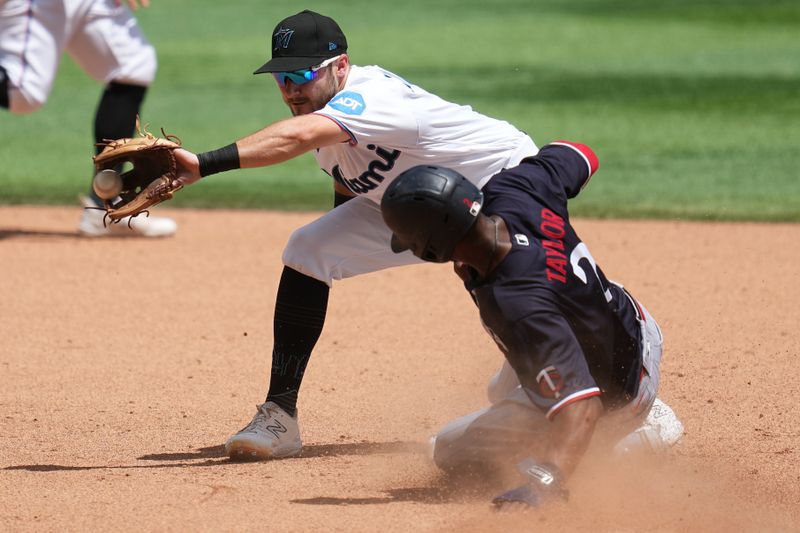 Apr 5, 2023; Miami, Florida, USA;  Minnesota Twins center fielder Michael A. Taylor (2) steals second base as Miami Marlins second baseman Garrett Hampson (1) covers the bag on the play in the sixth inning at loanDepot Park. Mandatory Credit: Jim Rassol-USA TODAY Sports