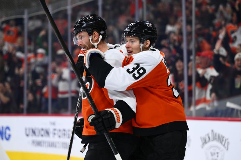 Oct 26, 2024; Philadelphia, Pennsylvania, USA; Philadelphia Flyers center Sean Couturier (14) celebrates with right wing Matvei Michkov (39) after scoring a goal against the Minnesota Wild in the first period at Wells Fargo Center. Mandatory Credit: Kyle Ross-Imagn Images