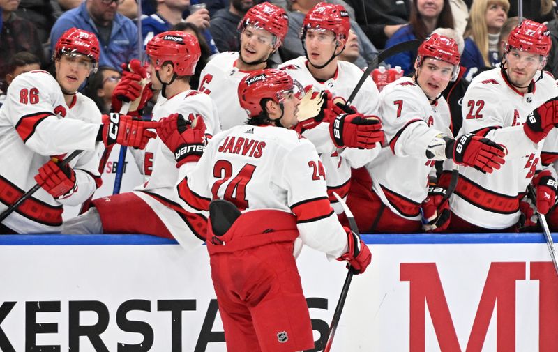 Dec 30, 2023; Toronto, Ontario, CAN; Carolina Hurricanes forward Seth Jarvis (24) celebrates with team mates after scoring a goal against the Toronto Maple Leafs in the second period at Scotiabank Arena. Mandatory Credit: Dan Hamilton-USA TODAY Sports