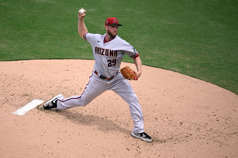 Aug 19, 2023; San Diego, California, USA; Arizona Diamondbacks starting pitcher Merrill Kelly (29) throws a pitch against the San Diego Padres during the first inning at Petco Park. Mandatory Credit: Orlando Ramirez-USA TODAY Sports