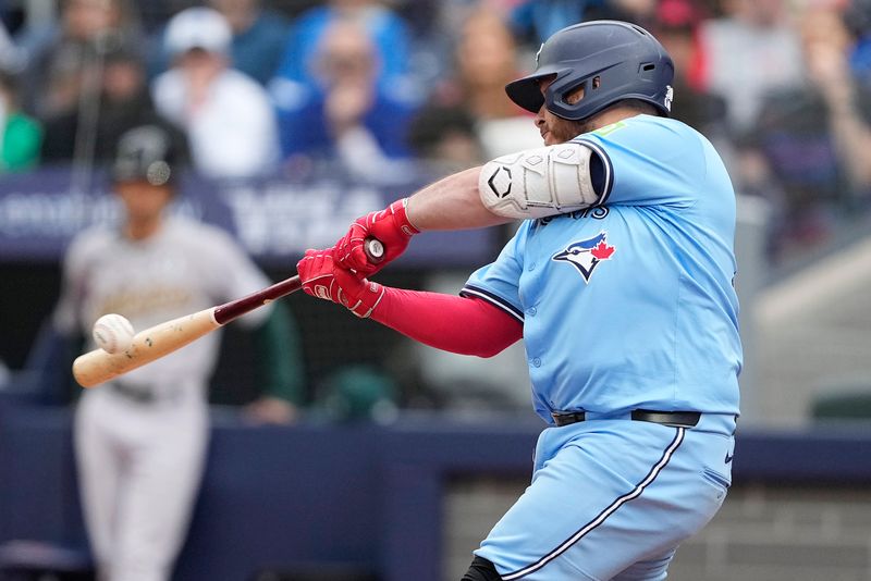 Jun 1, 2025; Toronto, Ontario, CAN; Toronto Blue Jays catcher Alejandro Kirk (30) hits an RBI double against the Oakland Athletics during the fifth inning at Rogers Centre. Mandatory Credit: John E. Sokolowski-Imagn Images