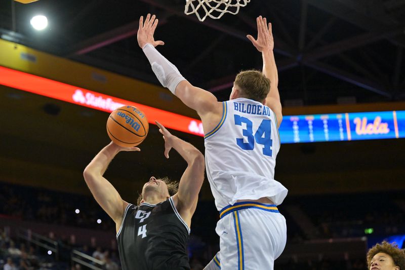 Dec 19, 2025; Los Angeles, California, USA; UCLA Bruins forward Tyler Bilodeau (34) blocks a shot by Cal Poly Mustangs guard Kieran Elliott (4) during the second half at Pauley Pavilion presented by Wescom Financial. Mandatory Credit: Jayne Kamin-Oncea-Imagn Images