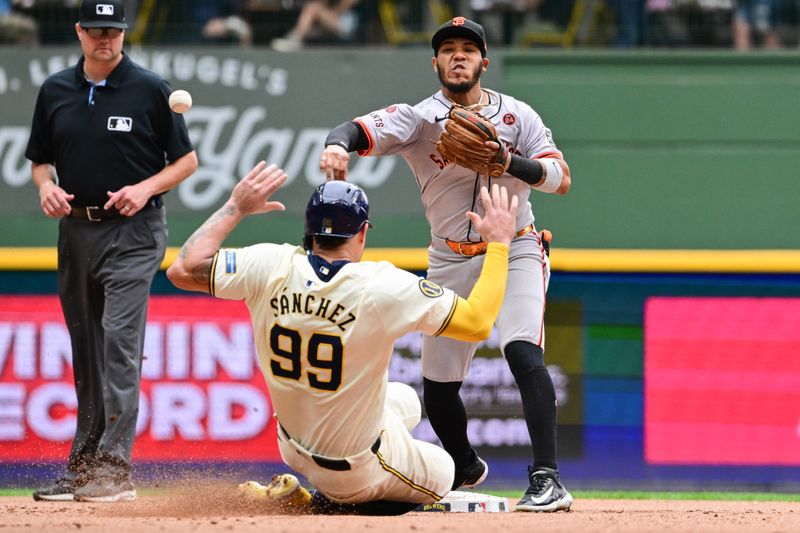 Aug 29, 2024; Milwaukee, Wisconsin, USA; San Francisco Giants second baseman Thairo Estrada (39) completes a double play after forcing out Milwaukee Brewers catcher Gary Sanchez (99) in the seventh inning at American Family Field. Mandatory Credit: Benny Sieu-USA TODAY Sports