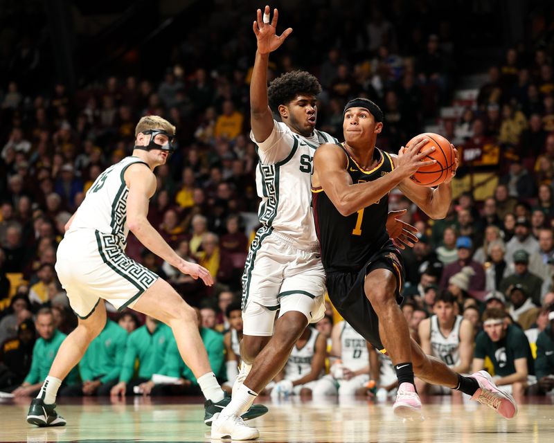 Dec 4, 2024; Minneapolis, Minnesota, USA; Minnesota Golden Gophers guard Isaac Asuma (1) works around Michigan State Spartans guard Jase Richardson (11) during the first half at Williams Arena. Mandatory Credit: Matt Krohn-Imagn Images