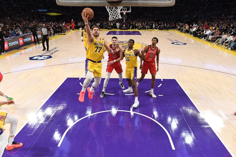 LOS ANGELES, CA - MARCH 4: Luka Doncic #77 of the Los Angeles Lakers drives to the basket during the game against the New Orleans Pelicans on March 4, 2025 at Crypto.Com Arena in Los Angeles, California. NOTE TO USER: User expressly acknowledges and agrees that, by downloading and/or using this Photograph, user is consenting to the terms and conditions of the Getty Images License Agreement. Mandatory Copyright Notice: Copyright 2025 NBAE (Photo by Juan Ocampo/NBAE via Getty Images)