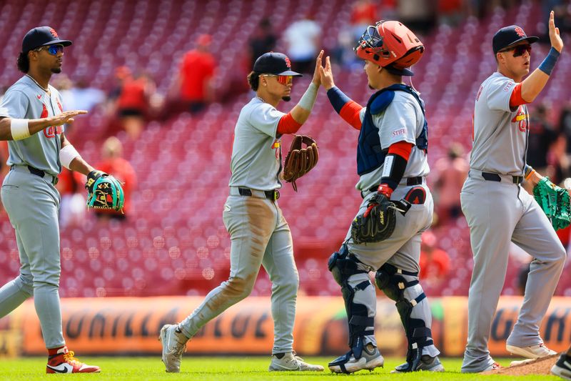Apr 30, 2025; Cincinnati, Ohio, USA; St. Louis Cardinals shortstop Masyn Winn (0) high fives catcher Yohel Pozo (63) after the victory over the Cincinnati Reds at Great American Ball Park. Mandatory Credit: Katie Stratman-Imagn Images