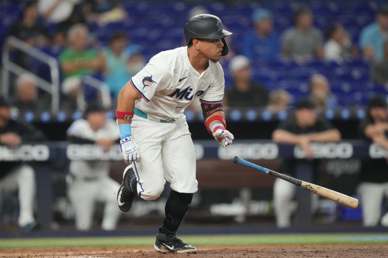 Aug 20, 2025; Miami, Florida, USA;  Miami Marlins designated hitter Heriberto Hernandez (64) hits a single in the fifth inning against the St. Louis Cardinals at loanDepot Park. Mandatory Credit: Jim Rassol-Imagn Images