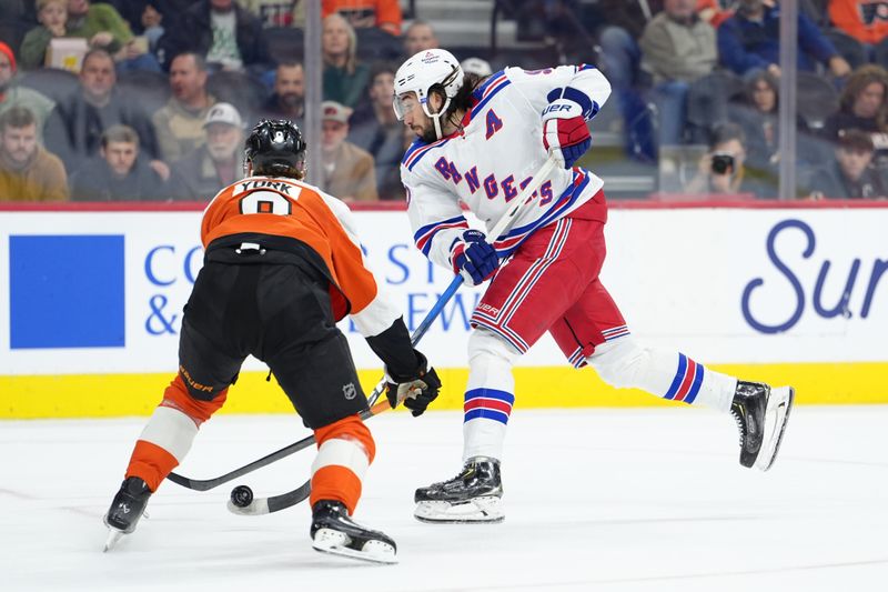 Jan 17, 2026; Philadelphia, Pennsylvania, USA; Philadelphia Flyers defenseman Cam York (8) defends a shot from New York Rangers center Mika Zibanejad (93) in the first period at Xfinity Mobile Arena. Mandatory Credit: Kyle Ross-Imagn Images