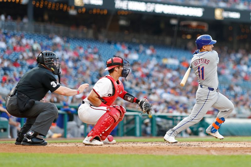 Jun 3, 2024; Washington, District of Columbia, USA; New York Mets shortstop Jose Iglesias (11) singles against the Washington Nationals during the second inning at Nationals Park. Mandatory Credit: Geoff Burke-USA TODAY Sports