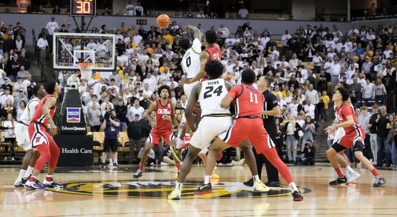 Mar 4, 2023; Columbia, Missouri, USA;Missouri Tigers forward Mohamed Diarra (0) and Mississippi Rebels forward Robert Allen (21) fight for the opening jump ball during the first half at Mizzou Arena. Mandatory Credit: Denny Medley-USA TODAY Sports