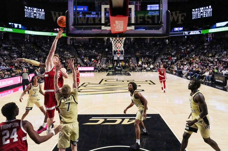 Feb 14, 2026; Winston-Salem, North Carolina, USA; Stanford Cardinal forward Oskar Giltay (15) shoots over Wake Forest Demon Deacons guard Isaac Carr (7) during the second half at Lawrence Joel Veterans Memorial Coliseum. Mandatory Credit: Jim Dedmon-Imagn Images