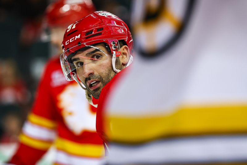 Dec 29, 2025; Calgary, Alberta, CAN; Calgary Flames center Nazem Kadri (91) during the face off against the Boston Bruins during the second period at Scotiabank Saddledome. Mandatory Credit: Sergei Belski-Imagn Images