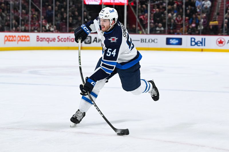 Jan 28, 2025; Montreal, Quebec, CAN; Winnipeg Jets defenseman Dylan Samberg (54) shoots the puck against the Montreal Canadiens during the first period at Bell Centre. Mandatory Credit: David Kirouac-Imagn Images