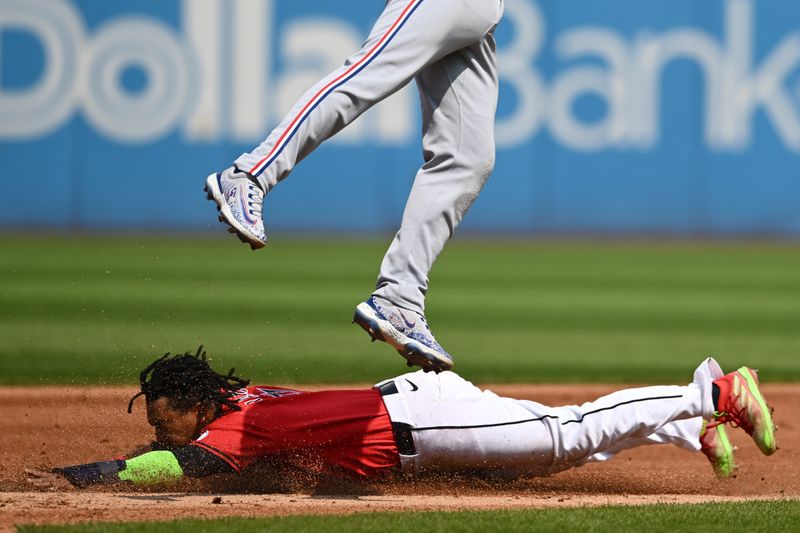 Aug 25, 2024; Cleveland, Ohio, USA; Cleveland Guardians third baseman Jose Ramirez (11) steals second base under exas Rangers second baseman Marcus Semien (2) during the third inning at Progressive Field. Mandatory Credit: Ken Blaze-USA TODAY Sports