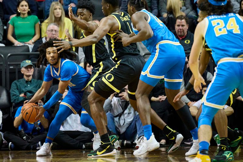 Feb 11, 2023; Eugene, Oregon, USA; UCLA Bruins guard Tyger Campbell (10) is double teamed by Oregon Ducks guard Jermaine Couisnard (5) and center N'Faly Dante (1) as he looks to pass the ball during the first half at Matthew Knight Arena. Mandatory Credit: Troy Wayrynen-USA TODAY Sports