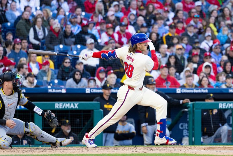 Apr 13, 2024; Philadelphia, Pennsylvania, USA; Philadelphia Phillies third base Alec Bohm (28) hits an RBI single during the eighth inning against the Pittsburgh Pirates at Citizens Bank Park. Mandatory Credit: Bill Streicher-USA TODAY Sports