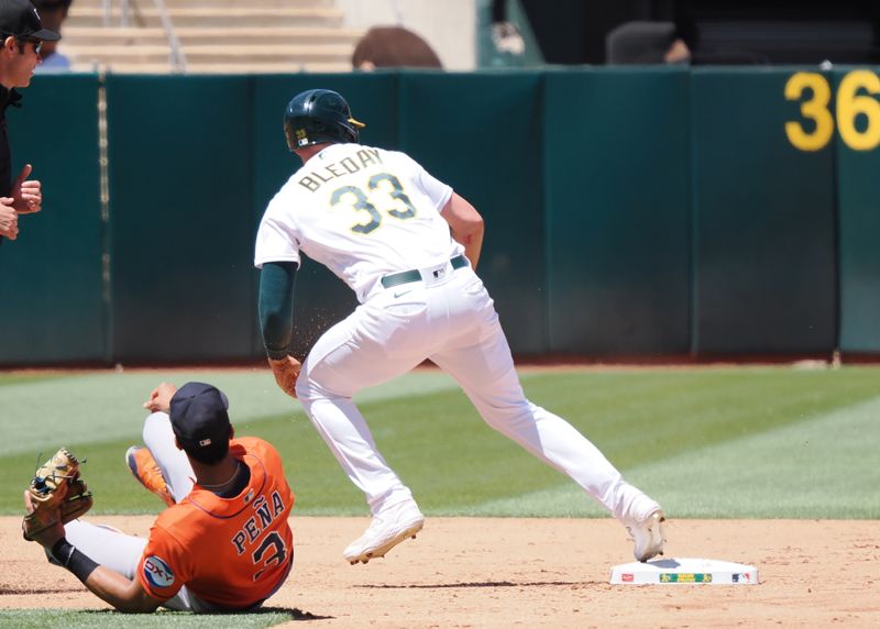 Jul 23, 2023; Oakland, California, USA; Oakland Athletics center fielder JJ Bleday (33) looks to run to third base after Houston Astros shortstop Jeremy Pena (3) is unable to catch him stealing second base on a throwing error by the Astros catcher during the sixth inning at Oakland-Alameda County Coliseum. Mandatory Credit: Kelley L Cox-USA TODAY Sports