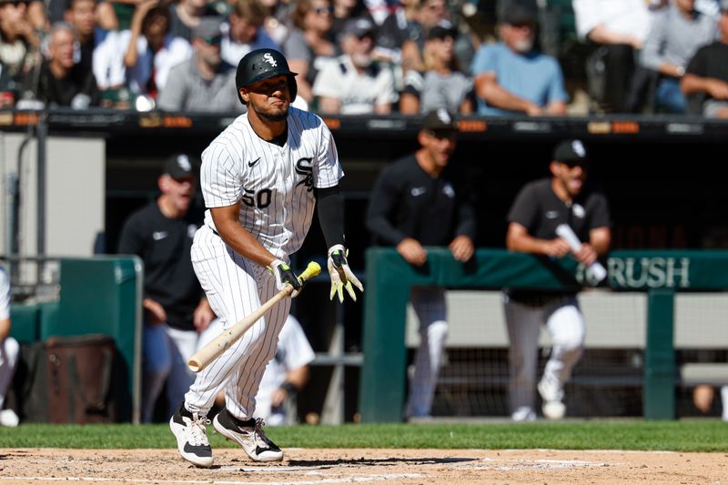 Sep 26, 2024; Chicago, Illinois, USA; Chicago White Sox third base Lenyn Sosa (50) hits a two-run double against the Los Angeles Angels during the fifth inning at Guaranteed Rate Field. Mandatory Credit: Kamil Krzaczynski-Imagn Images