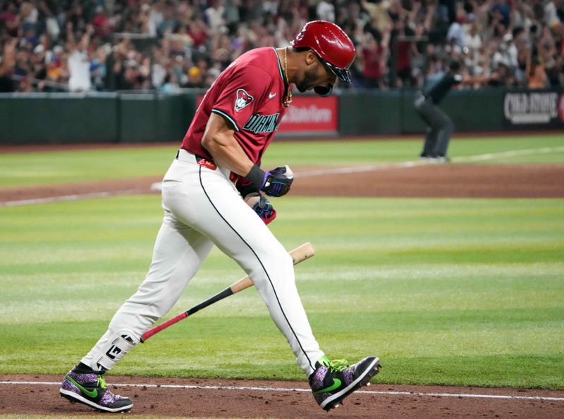 Jul 28, 2024; Phoenix, Arizona, USA; Arizona Diamondbacks outfielder Lourdes Gurriel Jr. (12) slams his bat after hitting a solo home run against the Pittsburgh Pirates during the tenth inning at Chase Field. Mandatory Credit: Joe Camporeale-USA TODAY Sports