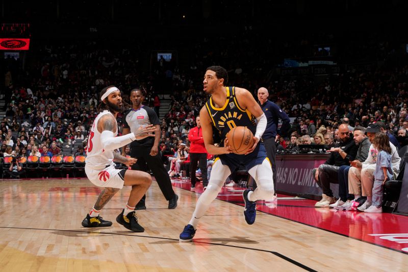 TORONTO, CANADA - APRIL 9: Tyrese Haliburton #0 of the Indiana Pacers handles the ball during the game against the Toronto Raptors on April 9, 2024 at the Scotiabank Arena in Toronto, Ontario, Canada.  NOTE TO USER: User expressly acknowledges and agrees that, by downloading and or using this Photograph, user is consenting to the terms and conditions of the Getty Images License Agreement.  Mandatory Copyright Notice: Copyright 2024 NBAE (Photo by Mark Blinch/NBAE via Getty Images)