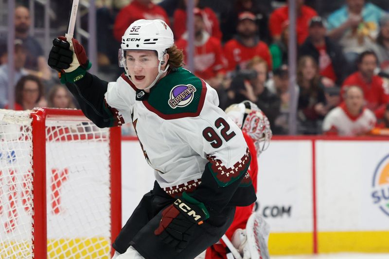 Mar 14, 2024; Detroit, Michigan, USA;  Arizona Coyotes center Logan Cooley (92) celebrates after he scores in the first period against the Detroit Red Wings at Little Caesars Arena. Mandatory Credit: Rick Osentoski-USA TODAY Sports