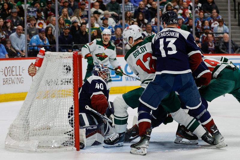 Apr 9, 2024; Denver, Colorado, USA; Minnesota Wild left wing Matt Boldy (12) scores a goal past Colorado Avalanche goaltender Alexandar Georgiev (40) as right wing Valeri Nichushkin (13) defends in the second period at Ball Arena. Mandatory Credit: Isaiah J. Downing-USA TODAY Sports