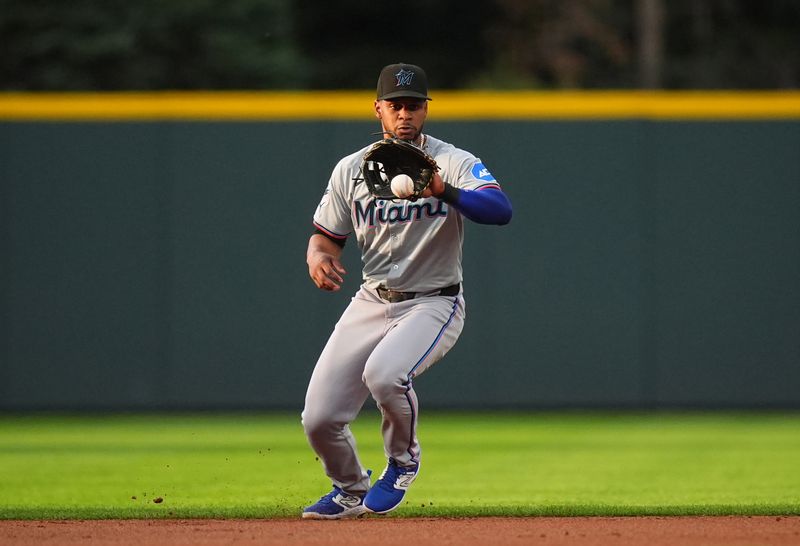 Aug 28, 2024; Denver, Colorado, USA; Miami Marlins second base Otto Lopez (61) fields the ball in the first inning against the Colorado Rockies at Coors Field. Mandatory Credit: Ron Chenoy-USA TODAY Sports