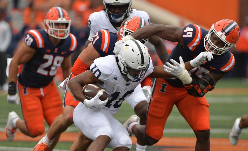 Sep 16, 2023; Champaign, Illinois, USA;  Penn State Nittany Lion running back Nicholas Singleton (10) runs the ball against Illinois Fighting Illini linebacker Seth Coleman (49) the second half at Memorial Stadium. Mandatory Credit: Ron Johnson-USA TODAY Sports