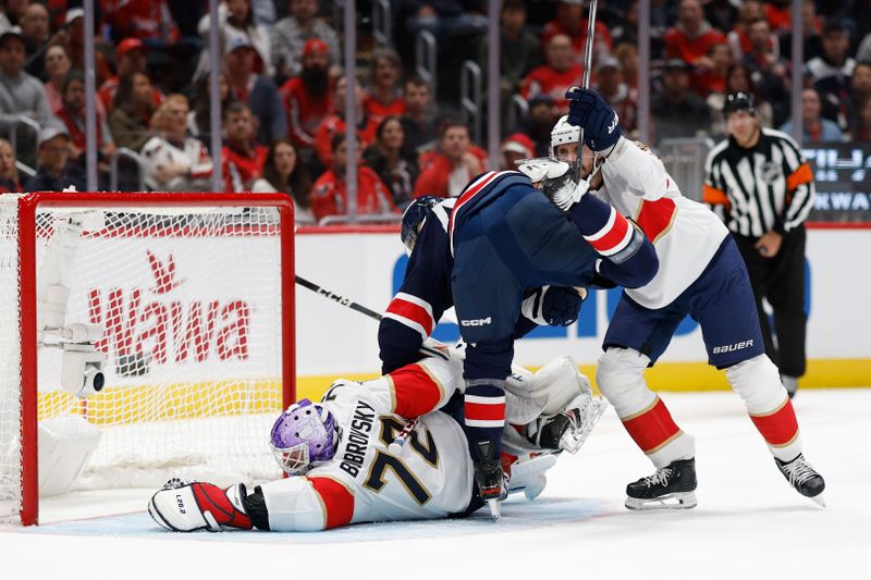 Nov 8, 2023; Washington, District of Columbia, USA; Florida Panthers goaltender Sergei Bobrovsky (72) makes a save on Washington Capitals defenseman Martin Fehervary (42) as Panthers defenseman Oliver Ekman-Larsson (91) defends in the first period at Capital One Arena. Mandatory Credit: Geoff Burke-USA TODAY Sports