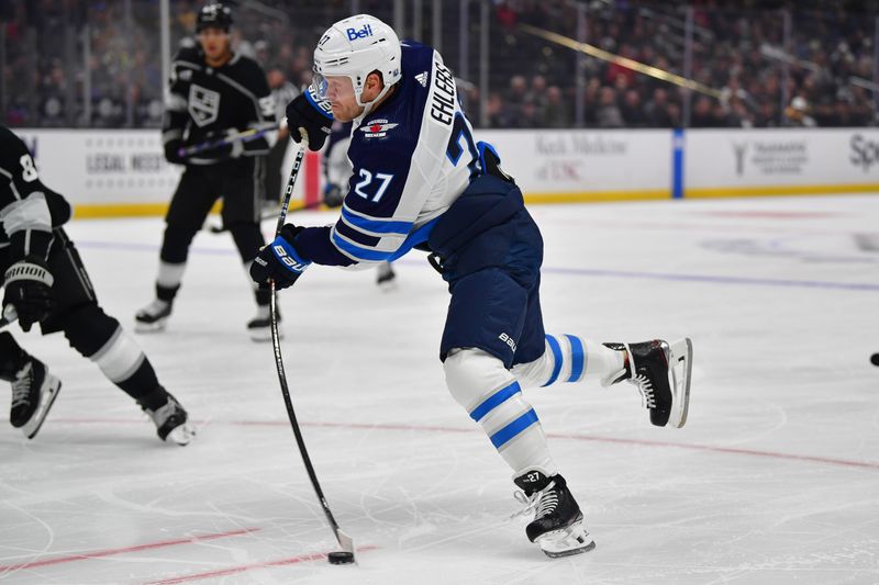 Dec 13, 2023; Los Angeles, California, USA; Winnipeg Jets left wing Nikolaj Ehlers (27) shoots on goal against the Los Angeles Kings during the first period at Crypto.com Arena. Mandatory Credit: Gary A. Vasquez-USA TODAY Sports