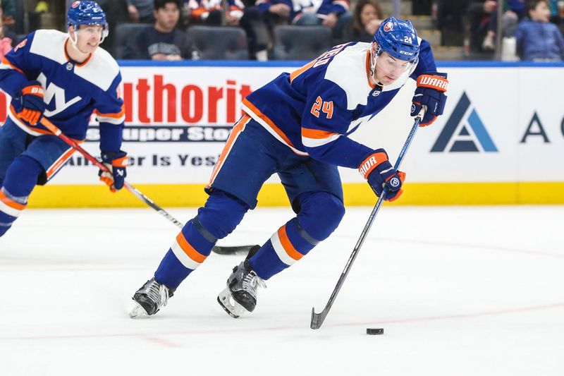 Feb 10, 2024; Elmont, New York, USA;  New York Islanders defenseman Scott Mayfield (24) controls the puck in the first period against the Calgary Flames at UBS Arena. Mandatory Credit: Wendell Cruz-USA TODAY Sports