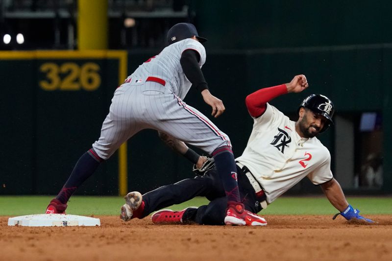 Sep 1, 2023; Arlington, Texas, USA; Minnesota Twins shortstop Carlos Correa (4) tags out  Texas Rangers second baseman Marcus Semien (2) on a force at second base during the sixth inning at Globe Life Field. Mandatory Credit: Raymond Carlin III-USA TODAY Sports