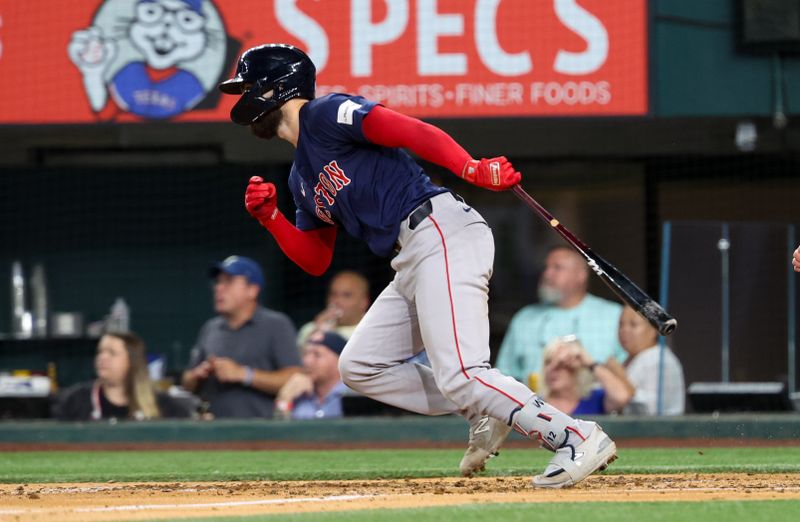 Aug 2, 2024; Arlington, Texas, USA; Boston Red Sox catcher Connor Wong (12) hits an rbi single during the fourth inning against the Texas Rangers at Globe Life Field. Mandatory Credit: Kevin Jairaj-USA TODAY Sports