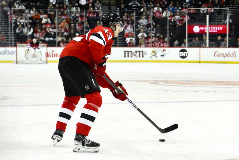 Jan 29, 2025; Newark, New Jersey, USA; New Jersey Devils defenseman Luke Hughes (43) controls the puck against the Philadelphia Flyers during the third period at Prudential Center. Mandatory Credit: John Jones-Imagn Images