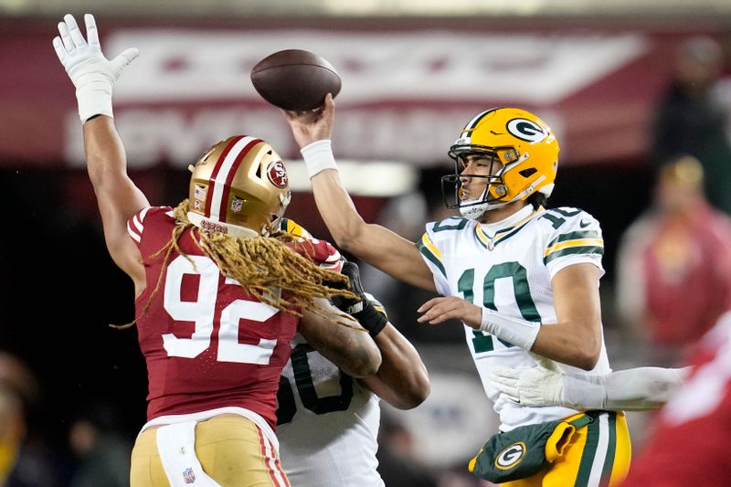 Green Bay Packers quarterback Jordan Love (10) throws a pass against San Francisco 49ers defensive end Chase Young (92) during an NFL football game Sunday, Jan. 21, 2024, in Inglewood, Calif. (AP Photo/Ashley Landis)