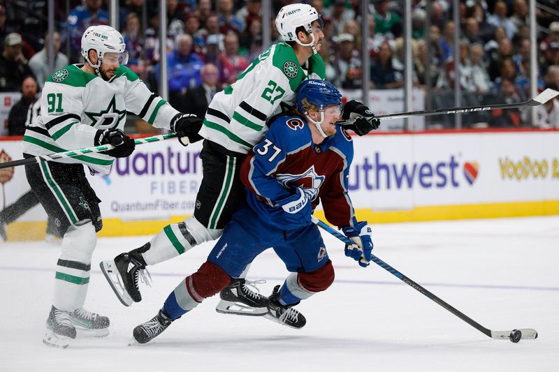 May 11, 2024; Denver, Colorado, USA; Colorado Avalanche center Casey Mittelstadt (37) is hit by Dallas Stars left wing Mason Marchment (27) as center Tyler Seguin (91) defends in the first period in game three of the second round of the 2024 Stanley Cup Playoffs at Ball Arena. Mandatory Credit: Isaiah J. Downing-USA TODAY Sports