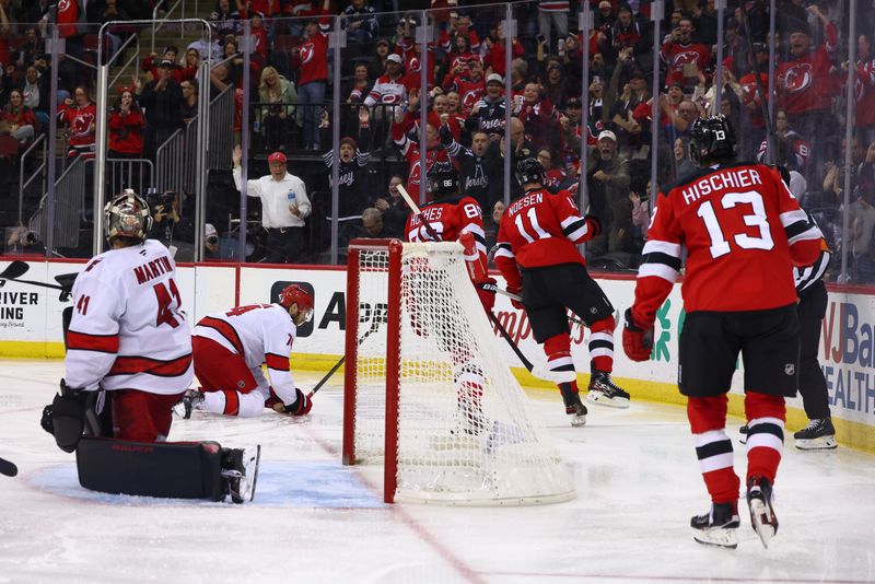 Nov 21, 2024; Newark, New Jersey, USA; New Jersey Devils right wing Stefan Noesen (11) celebrates his goal against the Carolina Hurricanes during the second period at Prudential Center. Mandatory Credit: Ed Mulholland-Imagn Images