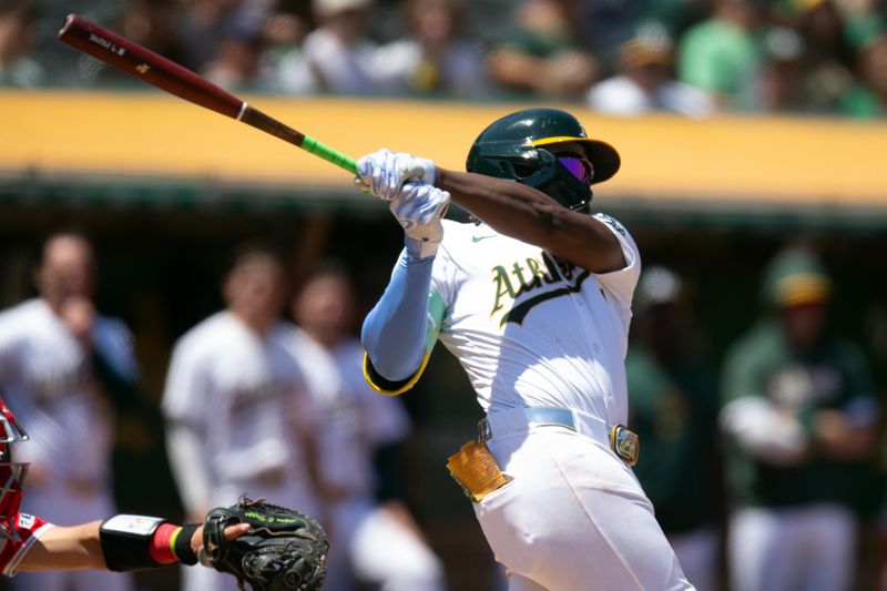 Jul 20, 2024; Oakland, California, USA; Oakland Athletics right fielder Lawrence Butler (4) follows through on his three-RBI double against the Los Angeles Angels during the fourth inning at Oakland-Alameda County Coliseum. Mandatory Credit: D. Ross Cameron-USA TODAY Sports