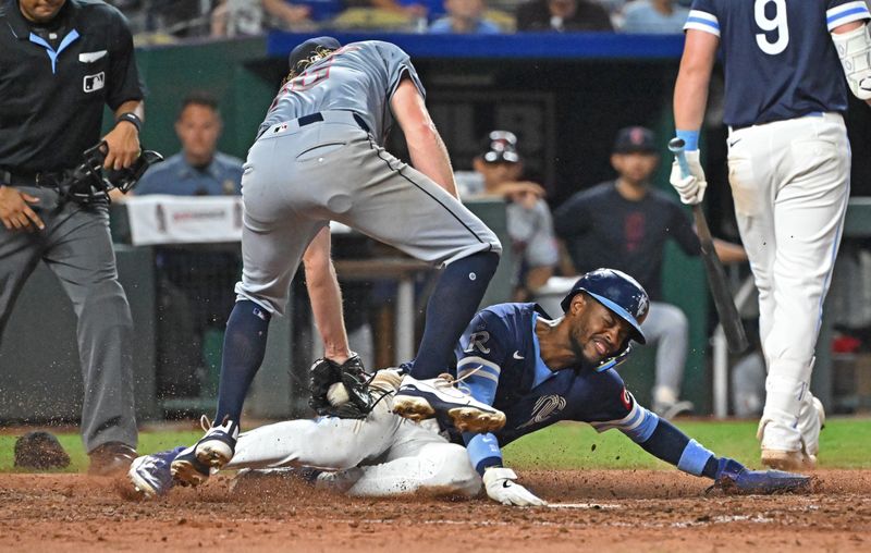 Jun 28, 2024; Kansas City, Missouri, USA;  Kansas City Royals second baseman Maikel Garcia (11) scores a run on a wild pitch against Cleveland Guardians relief pitcher Darren McCaughan (56) in the eighth inning at Kauffman Stadium. Mandatory Credit: Peter Aiken-USA TODAY Sports