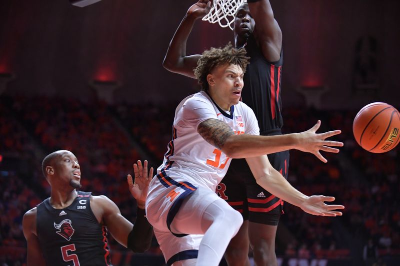 Jan 21, 2024; Champaign, Illinois, USA; Illinois Fighting Illini forward Coleman Hawkins (33) passes the ball by Rutgers Scarlet Knights forward Aundre Hyatt (5) during the first half at State Farm Center. Mandatory Credit: Ron Johnson-USA TODAY Sports