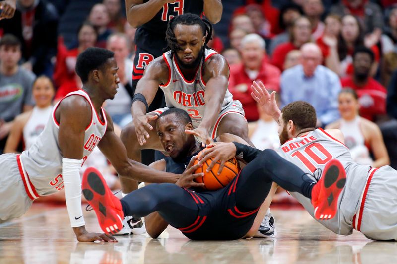 Jan 3, 2024; Columbus, Ohio, USA; Rutgers Scarlet Knights forward Mawot Mag (center) fights for the loose ball with Ohio State Buckeyes guard Scotty Middleton (left) and Ohio State Buckeyes guard Bruce Thornton (2) and Ohio State Buckeyes forward Jamison Battle (10) during the second half at Value City Arena. Mandatory Credit: Joseph Maiorana-USA TODAY Sports