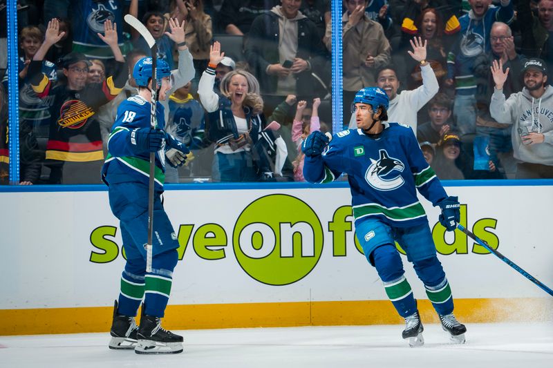 Oct 13, 2025; Vancouver, British Columbia, CAN; Vancouver Canucks forward Drew O'Connor (18) and forward Kiefer Sherwood (44) celebrate Sherwood’s second goal of the game against the St. Louis Blues in the second period at Rogers Arena. Mandatory Credit: Bob Frid-Imagn Images