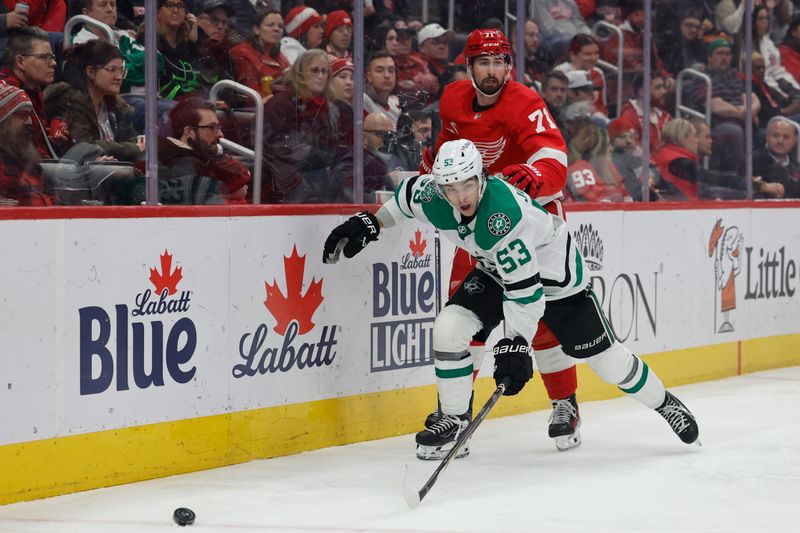 Jan 23, 2024; Detroit, Michigan, USA;  Dallas Stars center Wyatt Johnston (53) skates with the puck chased by Detroit Red Wings center Dylan Larkin (71) in the first period at Little Caesars Arena. Mandatory Credit: Rick Osentoski-USA TODAY Sports