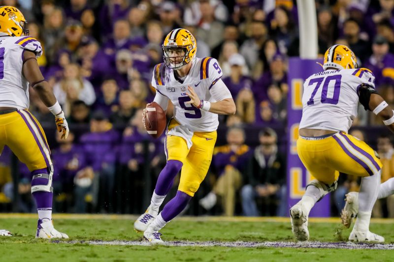 Nov 23, 2019; Baton Rouge, LA, USA; LSU Tigers quarterback Joe Burrow (9) scrambles out the pocket against Arkansas Razorbacks during the first half at Tiger Stadium. Mandatory Credit: Stephen Lew-USA TODAY Sports