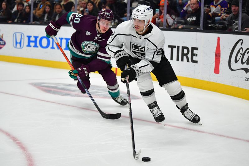 Nov 24, 2023; Anaheim, California, USA; Los Angeles Kings left wing Kevin Fiala (22) moves the puck ahead of Anaheim Ducks defenseman Jackson LaCombe (60) during the third period at Honda Center. Mandatory Credit: Gary A. Vasquez-USA TODAY Sports