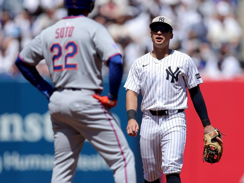 May 17, 2025; Bronx, New York, USA; New York Yankees shortstop Anthony Volpe (11) talks to New York Mets right fielder Juan Soto (22) at second base during the fourth inning at Yankee Stadium. Mandatory Credit: Brad Penner-Imagn Images