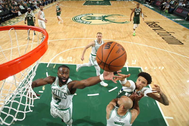 MILWAUKEE, WI - NOVEMBER 10: Jaylen Brown #7 of the Boston Celtics and Ryan Rollins #13 of the Milwaukee Bucks go for a rebound during the game on November 10, 2024 at the Fiserv Forum Center in Milwaukee, Wisconsin. NOTE TO USER: User expressly acknowledges and agrees that, by downloading and or using this Photograph, user is consenting to the terms and conditions of the Getty Images License Agreement. Mandatory Copyright Notice: Copyright 2024 NBAE (Photo by Gary Dineen/NBAE via Getty Images).