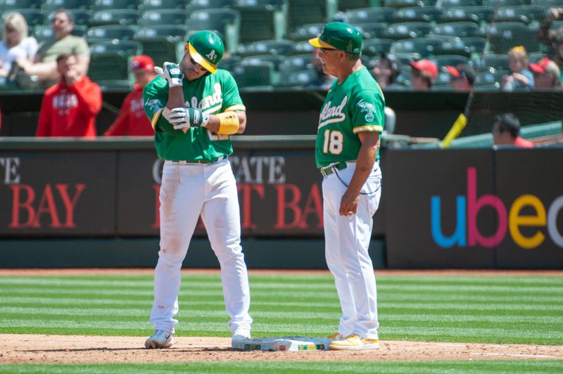 Apr 29, 2023; Oakland, California, USA; Oakland Athletics right fielder Ramon Laureano (22) examines his elbow after being hit by a pitch during the fourth inning at RingCentral Coliseum. Mandatory Credit: Ed Szczepanski-USA TODAY Sports